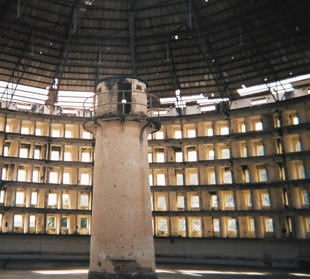 Middle tower surrounded by prison cells, panopticon style