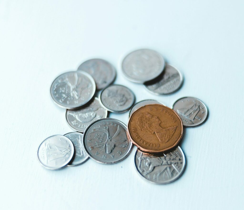 small collection of coins on white surface