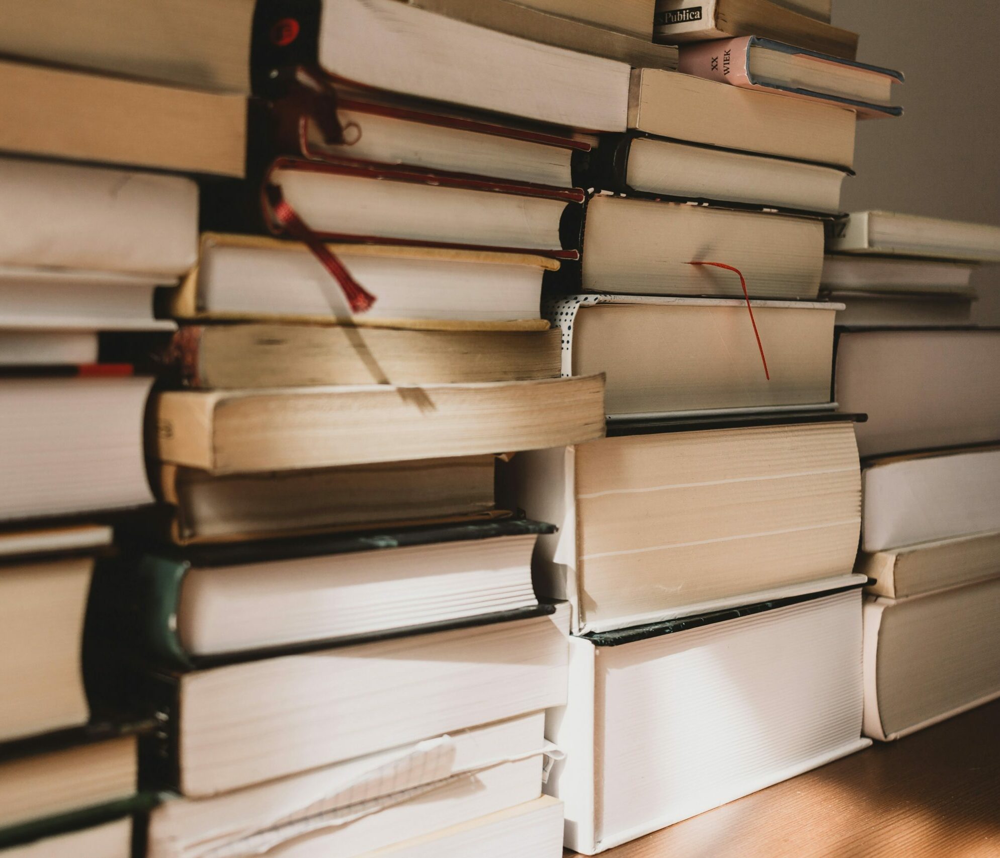 Stack of books in sunlight on a desk